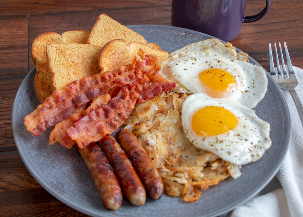 Eggs, bacon, sausage, hash browns and toast